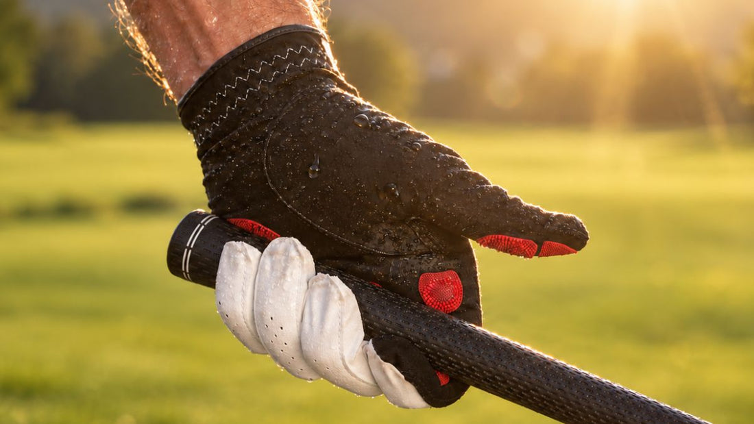EXO golf glove with red Zyntech nanocell grip pads, wet with water droplets, gripping a golf club.
