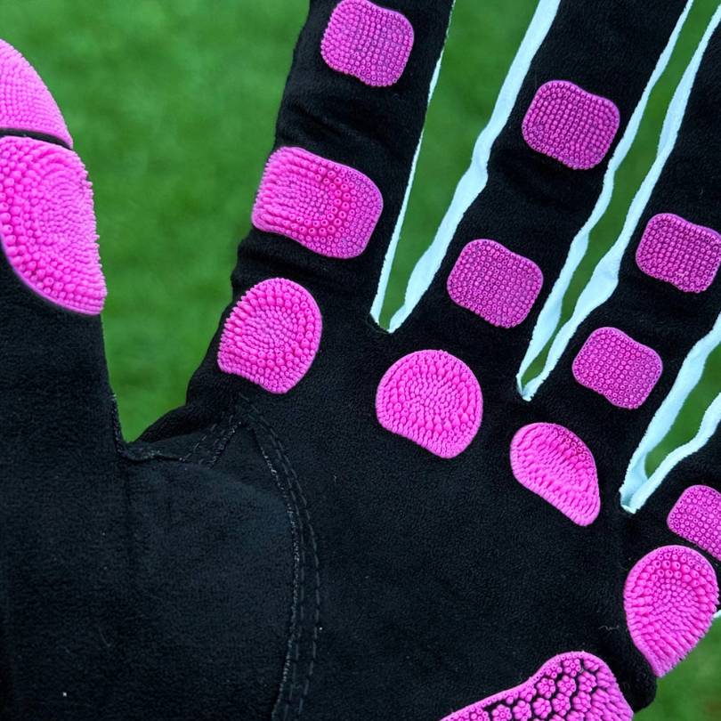 EXO Golf Glove pink colorway close up showing Zyntech™ nanocell grip pads mapped across palm and fingers