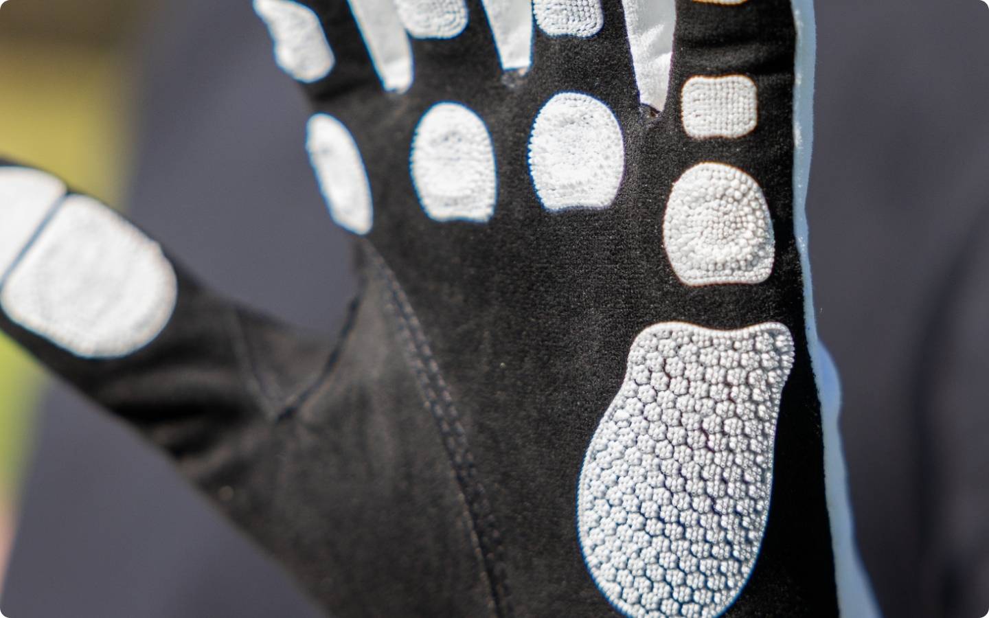 EXO Golf Glove white colorway close up showing Zyntech nanocell grip pad texture across palm and fingers