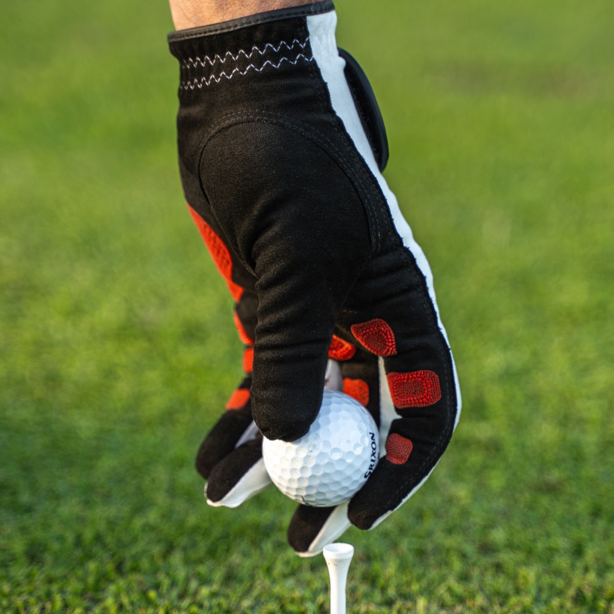 EXO Golf Glove with red nanocells - placing a ball on a tee