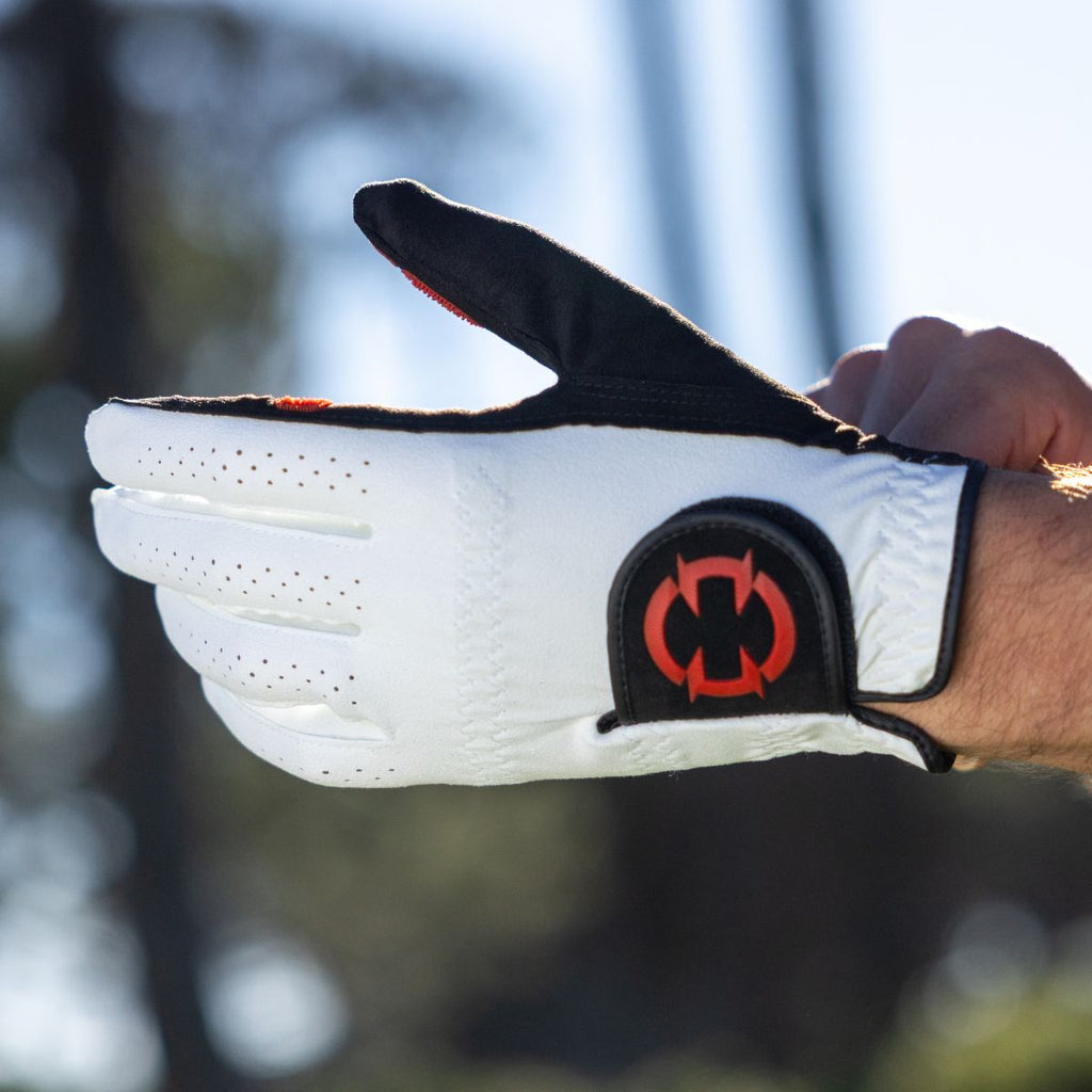 EXO golf glove with red logo - golfer putting the glove on with logo showing